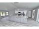 Spacious kitchen with a granite island, stainless steel appliances, and gray wood flooring at 211 Marion Oaks Ln, Ocala, FL 34473