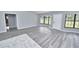 Bright living room with gray wood flooring, a bay window and a white front door at 211 Marion Oaks Ln, Ocala, FL 34473