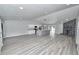 Open-concept living space featuring hardwood floors, a stone fireplace, and modern lighting at 211 Marion Oaks Ln, Ocala, FL 34473