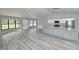 Open living space with a modern kitchen, granite countertops, stainless appliances, and bright natural light at 211 Marion Oaks Ln, Ocala, FL 34473