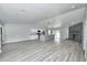 Spacious living area with a modern kitchen, island seating, recessed lighting, and a unique stone fireplace design at 211 Marion Oaks Ln, Ocala, FL 34473