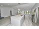 Open-concept with hardwood floors, granite island, stone fireplace and large windows at 211 Marion Oaks Ln, Ocala, FL 34473