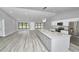 Modern living space with hardwood floors, granite island, and plenty of natural light at 211 Marion Oaks Ln, Ocala, FL 34473