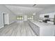Bright, airy living space featuring a modern kitchen with an island, ample natural light, and sleek hardwood floors at 211 Marion Oaks Ln, Ocala, FL 34473