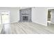 Living room with rock fireplace and wood-look flooring at 211 Marion Oaks Ln, Ocala, FL 34473