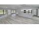 Open-concept area with hardwood floors, granite countertops and large windows at 211 Marion Oaks Ln, Ocala, FL 34473