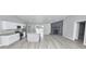 Open-concept kitchen and living area with granite countertops and a stone fireplace at 211 Marion Oaks Ln, Ocala, FL 34473