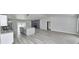 Open-concept living space featuring a modern kitchen island, a stone fireplace, and sleek flooring throughout at 211 Marion Oaks Ln, Ocala, FL 34473