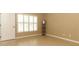 Bedroom with laminate floors, white window shutters, and natural light at 212 Regency St, Davenport, FL 33896