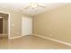 Spacious bedroom featuring neutral walls, wood-look tile flooring, and a ceiling fan at 212 Regency St, Davenport, FL 33896