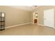 Bedroom with laminate floors, neutral walls, and access to the bathroom at 212 Regency St, Davenport, FL 33896