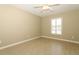 Bedroom with neutral walls, wood-look tile, ceiling fan, and a window with shutters at 212 Regency St, Davenport, FL 33896