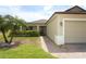 Lovely home featuring a tropical palm tree, stone walkway and covered entryway with nice landscaping at 212 Regency St, Davenport, FL 33896
