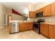 The kitchen features stainless steel appliances, wood cabinets, tile floors and plenty of counter space at 212 Regency St, Davenport, FL 33896