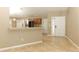 Open kitchen view from the entryway; featuring counter seating, tile flooring, and stainless steel appliances at 212 Regency St, Davenport, FL 33896