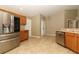 Spacious kitchen features stainless steel appliances, tile floors, wooden cabinets and ample counter space at 212 Regency St, Davenport, FL 33896