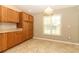 Bright kitchen featuring tile floors, wood cabinets and a large window for natural light at 212 Regency St, Davenport, FL 33896