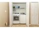 Bright laundry area features a modern washer and dryer set with white shaker doors and tile flooring at 212 Regency St, Davenport, FL 33896