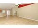 Open-concept living room with tile floors, ceiling fan, and access to entryway at 212 Regency St, Davenport, FL 33896