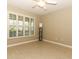 Living room with wood-look tile, shutters, a ceiling fan, and shelving at 212 Regency St, Davenport, FL 33896