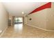Living room with tile flooring, a ceiling fan, access to the porch, and mounted tv connection at 212 Regency St, Davenport, FL 33896