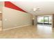 Open floorplan living room area, featuring tile floors, a ceiling fan, and access to the porch at 212 Regency St, Davenport, FL 33896