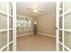 Living room with wood-look tile, shutters, a ceiling fan, and open doorway at 212 Regency St, Davenport, FL 33896