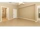 Main bedroom with laminate floors, neutral walls, and an ensuite bathroom at 212 Regency St, Davenport, FL 33896