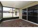 Enclosed patio with brick floors leading to sliding glass doors and outdoor living at 212 Regency St, Davenport, FL 33896
