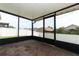 Screened lanai featuring brick-paved flooring and views of the backyard, providing a relaxing retreat at 212 Regency St, Davenport, FL 33896
