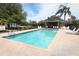 Community pool features lounge chairs, blue water, and shade for residents to enjoy the outdoor recreation at 212 Regency St, Davenport, FL 33896