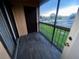Enclosed balcony with dark wood-look flooring and a view of the outdoors at 2131 Cascades Blvd # 306, Kissimmee, FL 34741