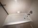 Clean white bathtub with chrome fixtures and tiled surround at 2131 Cascades Blvd # 306, Kissimmee, FL 34741