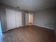 Bedroom with wood-look floors and closet with bi-fold doors at 2131 Cascades Blvd # 306, Kissimmee, FL 34741