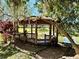 Charming wooden gazebo nestled in a landscaped community area at 2131 Cascades Blvd # 306, Kissimmee, FL 34741