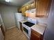 Close up of the kitchen with white appliances and wood cabinets at 2131 Cascades Blvd # 306, Kissimmee, FL 34741