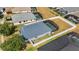 Aerial view of property showcasing screen enclosed pool, back yard, and neighborhood at 2709 Prestwick Ln, Kissimmee, FL 34744