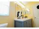 Bathroom showcasing a double sink vanity, modern lighting and framed mirrors at 2709 Prestwick Ln, Kissimmee, FL 34744
