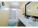 Bright bathroom features a double sink vanity, marble-walled shower/tub, and decorative accents at 2709 Prestwick Ln, Kissimmee, FL 34744