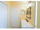 Well-lit bathroom featuring a quartz countertop, modern sink fixture, and a framed mirror above the sink at 2709 Prestwick Ln, Kissimmee, FL 34744
