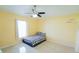 Bright bedroom showcases a ceiling fan and tile flooring at 2709 Prestwick Ln, Kissimmee, FL 34744