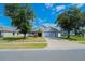 Charming single-story home featuring a well-manicured lawn, mature trees, and inviting curb appeal at 2709 Prestwick Ln, Kissimmee, FL 34744