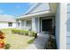 Inviting covered front porch with seating area, decorative plants and shade for relaxing outdoors at 2709 Prestwick Ln, Kissimmee, FL 34744