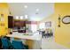 Open kitchen boasts dark wood cabinetry, stainless steel appliances, and an adjacent dining area at 2709 Prestwick Ln, Kissimmee, FL 34744