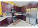 Modern kitchen with dark wood cabinets, stainless steel appliances, and white countertops at 2709 Prestwick Ln, Kissimmee, FL 34744