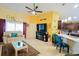 Open-concept living room featuring tile floors, a ceiling fan, and a view into the adjacent kitchen at 2709 Prestwick Ln, Kissimmee, FL 34744