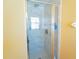 Shower with glass doors and marble-patterned tile at 2709 Prestwick Ln, Kissimmee, FL 34744