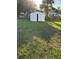 Fenced backyard with a storage shed and green grass at 3040 Pinder Ct, Orlando, FL 32811