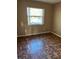 Bedroom with wood-patterned flooring and a window offering natural light at 3040 Pinder Ct, Orlando, FL 32811