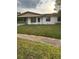 Charming single-story home featuring a well-maintained front yard and covered parking at 3040 Pinder Ct, Orlando, FL 32811
